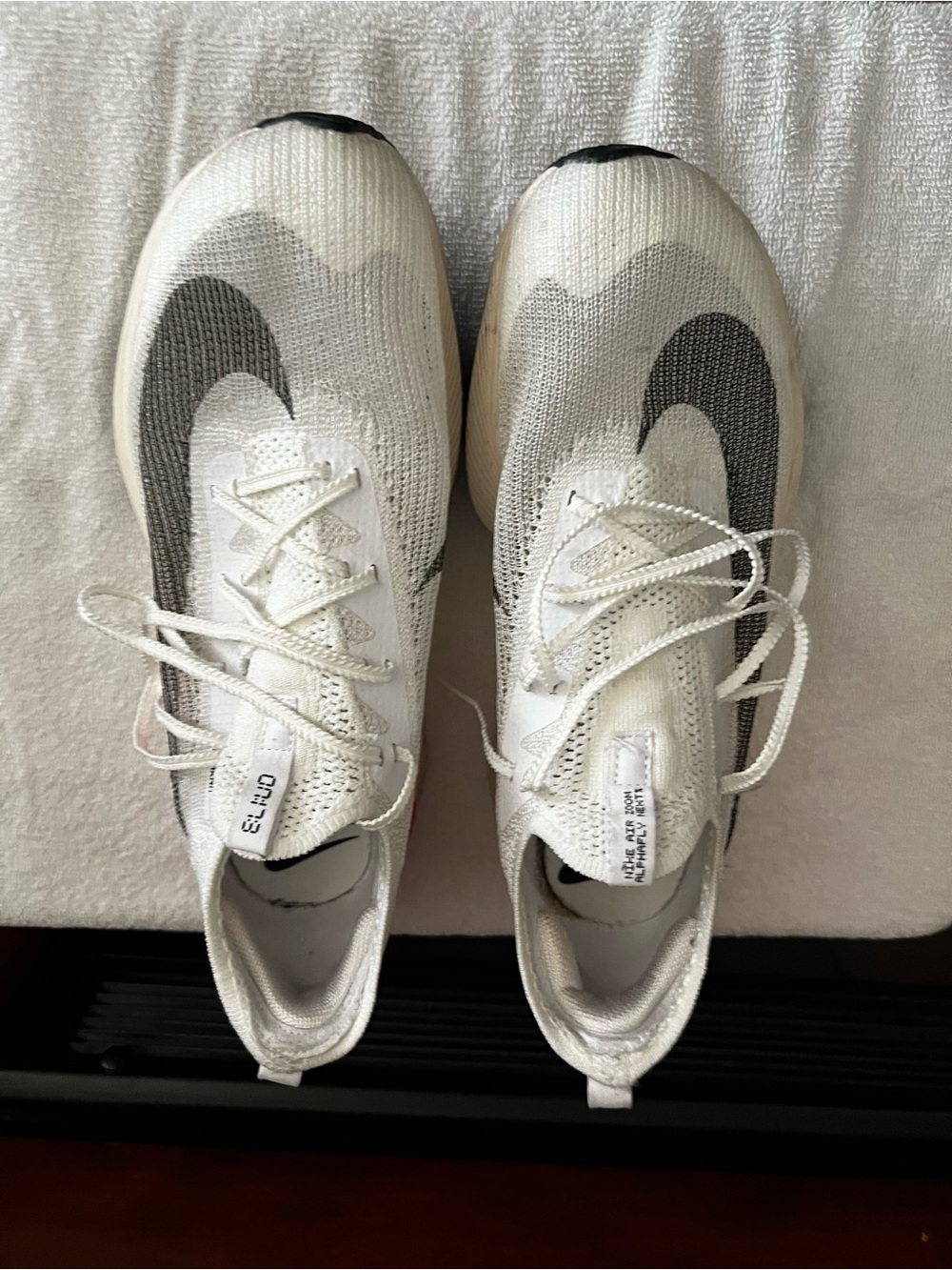Nike White Flyknit Running Shoes with Black Swoosh